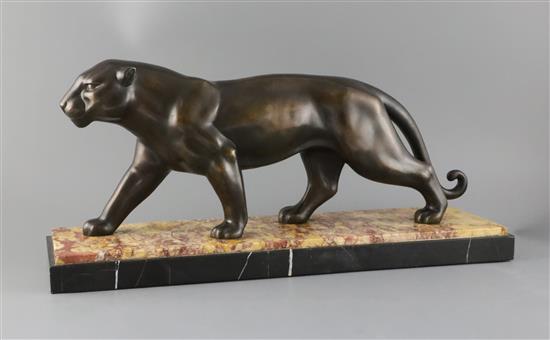 A French Art Deco PATINATED SPELTER model of a prowling panther, width 21.75in. depth 6.25in. height 10in.